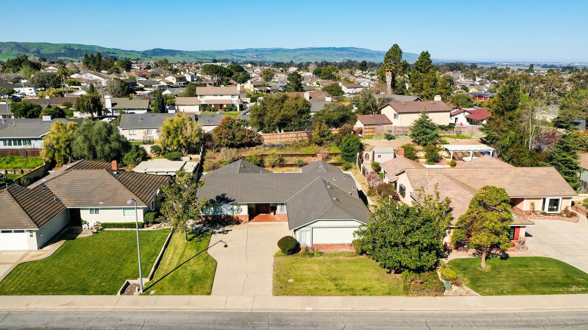 Aerial view of a Central Coast home surrounded by green hills